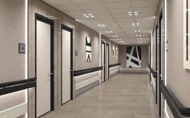 A hallway with resident doors and artwork