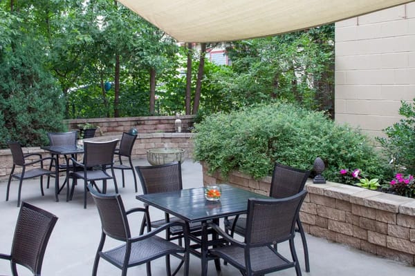 Outdoor seating area with plants and tables