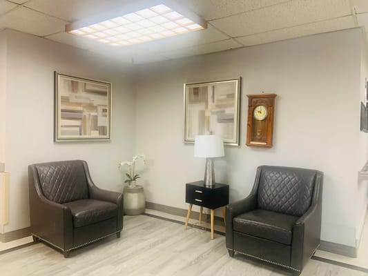 Cozy seating area with artwork and clock