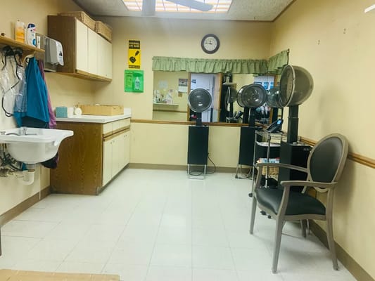 Interior view of a salon area with styling chairs and hair dryers