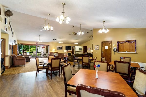 Bright common area with tables and seating at Twin Cedar Senior Living