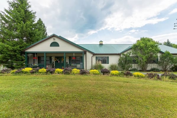 Front view of Twin Cedar Senior Living facility with green landscaping