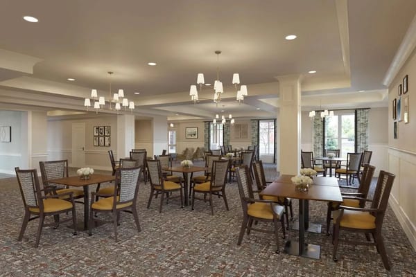 Bright dining room with tables and chairs for residents