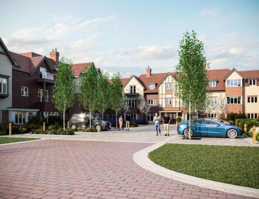 Exterior view of a senior living facility with residents and vehicles