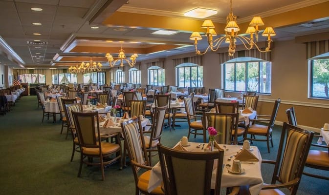 Spacious dining room with tables set for meals at Calusa Harbour