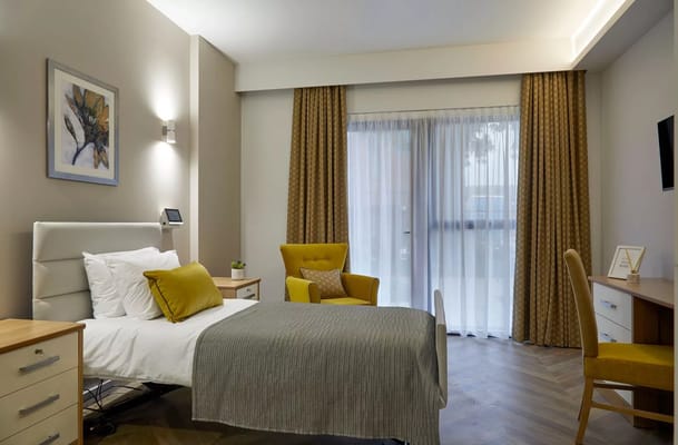 Cozy resident room with bed and seating area