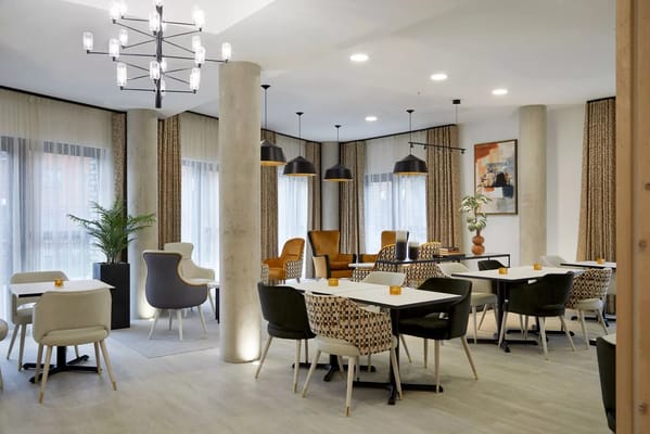 Bright common area with dining tables and seating