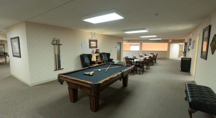 Common area with a pool table and dining setup