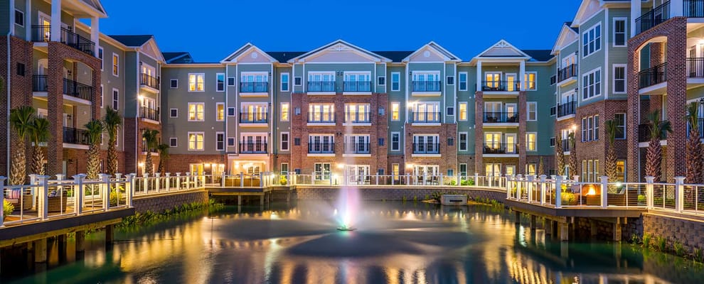 Exterior view of a modern assisted living facility at night