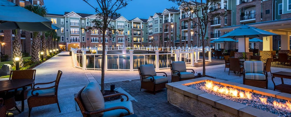 Outdoor courtyard with seating and fire pit at dusk