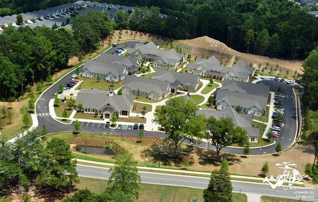 Aerial view of Camellia Place senior living facility showing a cluster of buildings and surrounding greenery.