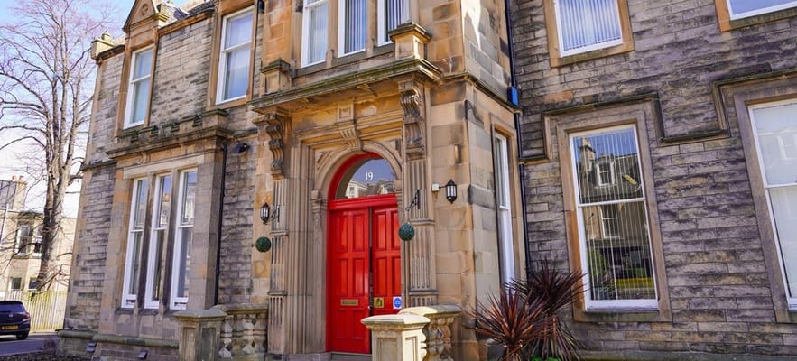 Facade of an assisted living facility with red door