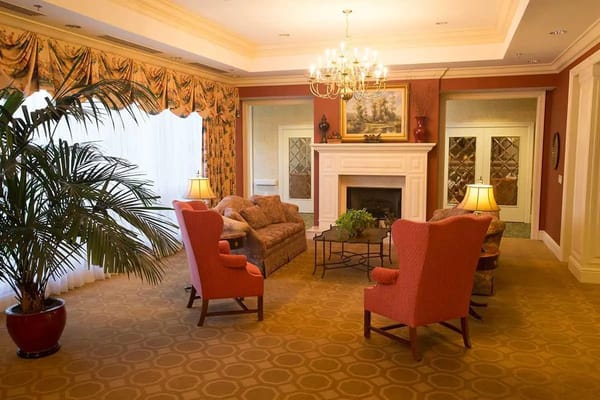 A cozy common area with comfortable seating and a fireplace