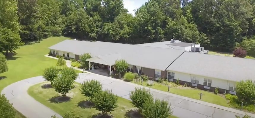 Aerial view of a nursing home building with landscaped grounds