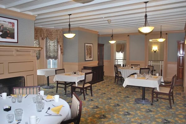 Cozy dining room with tables set for meals