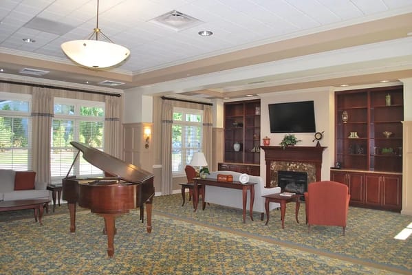 Comfortable lounge with piano and fireplace