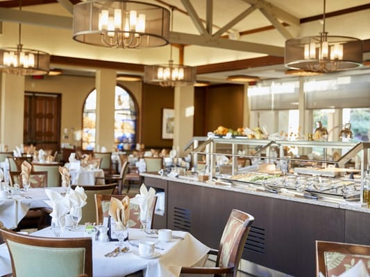 Bright dining room with buffet setup and elegant decor