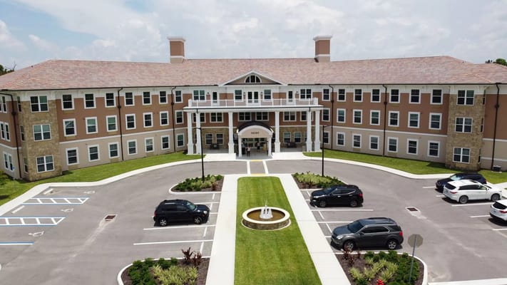 Exterior view of a senior living facility with landscaping