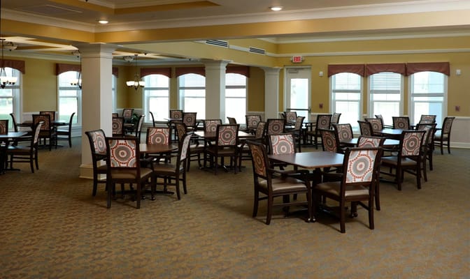 Bright dining area with arranged tables and chairs