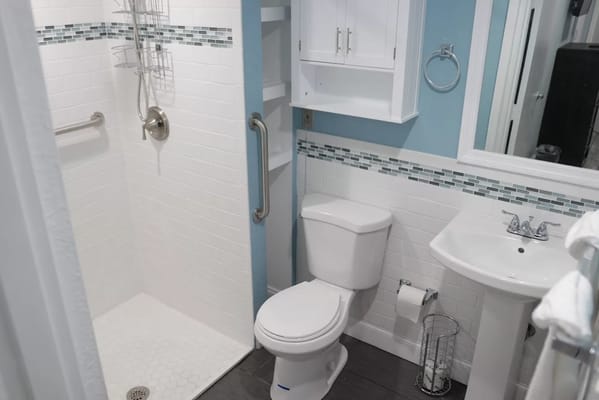 Modern bathroom with shower, toilet, and sink