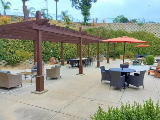 Outdoor patio with seating and umbrellas at Canyon Villas.