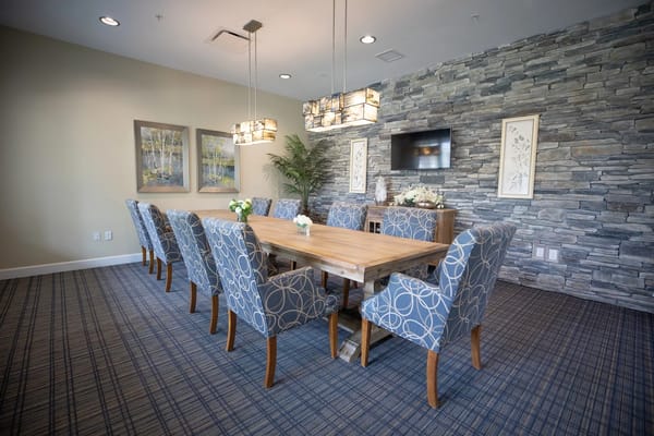 Spacious dining room with a wooden table and patterned chairs
