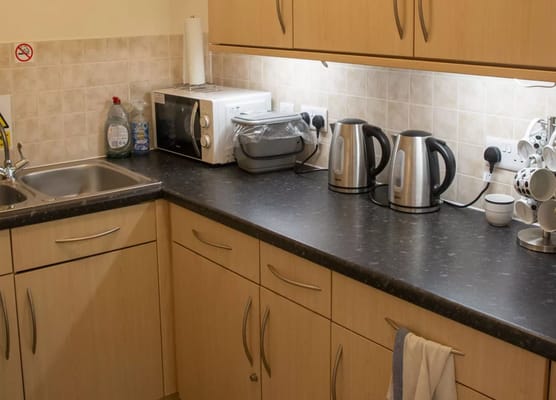 Interior kitchen area with appliances and dark countertop