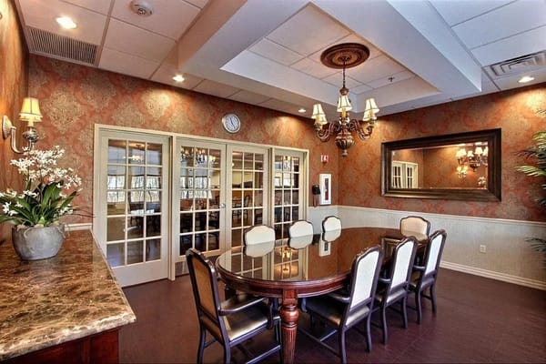 Elegant common area with a dining table and chandelier