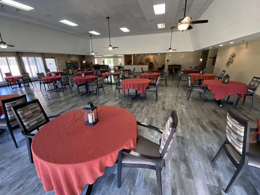 Interior of the dining area with red tablecloths and chairs
