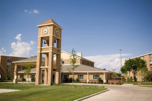 Exterior view of a senior living facility with a clock tower
