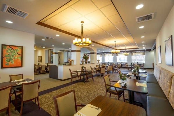 Bright dining room with tables and decorative plants