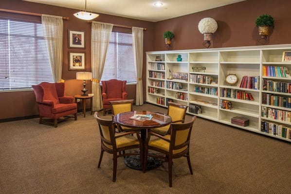 Cozy common area with bookshelves and comfortable seating