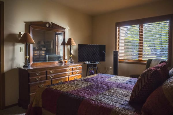 Cozy bedroom with a dresser and window