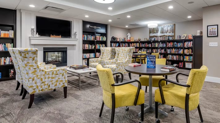 Cozy interior common area with bookshelves and seating
