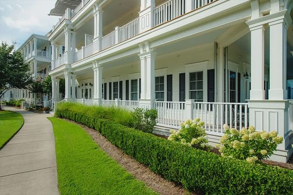 Exterior view of a residential facility with landscaped pathway