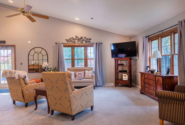 Comfortable seating area in the living room with a TV and decorative plants