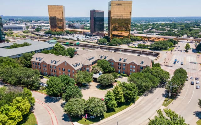 Aerial view of a senior living facility surrounded by greenery