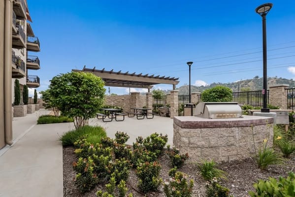 Outdoor patio area with seating and BBQ grill