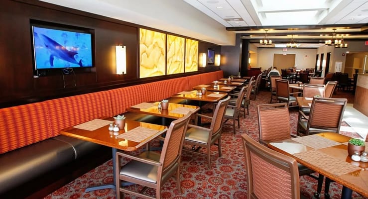 Dining area with tables and chairs in a bright setting