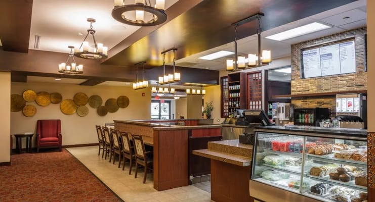 Interior of a dining area with seating and food display
