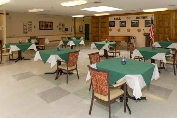 Dining room with green tablecloths and an American flag