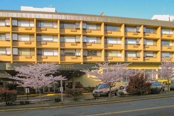 Facade of Cascade Park Vista with cherry blossom trees
