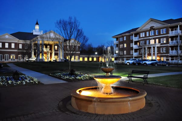 Exterior view of Cascades Verdae with fountain and evening lighting