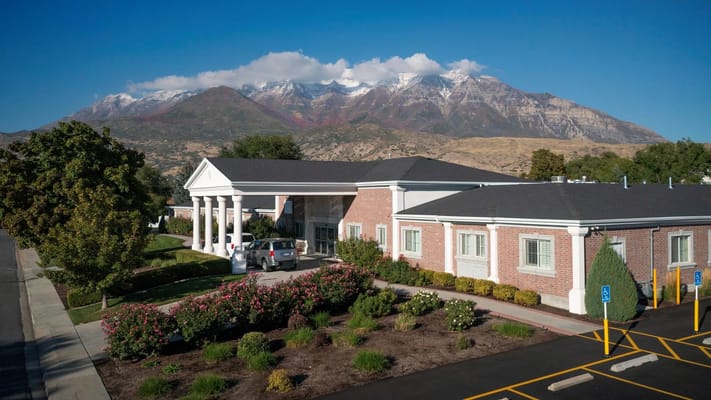 Front entrance of Cascades at Orchard Park with surrounding landscape and mountains in the background