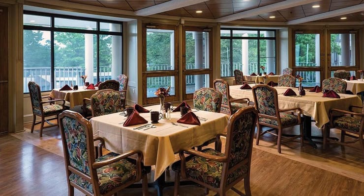 Elegant dining room setup with floral decor and table settings