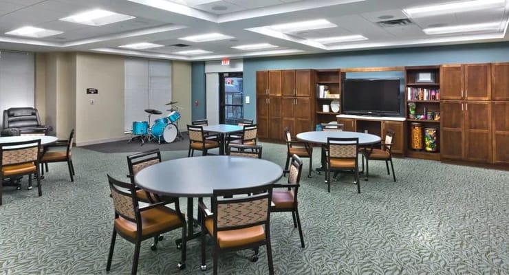 Common area with circular tables and a TV