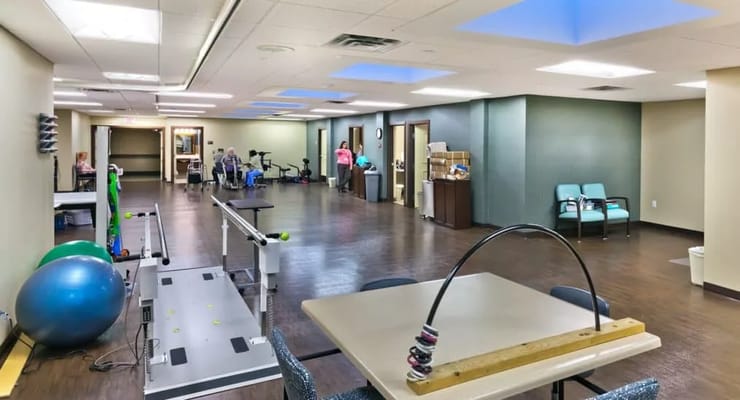 Interior view of a senior care activity room with gym equipment