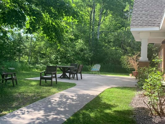 Outdoor patio with seating in a green landscape