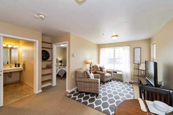 Cozy resident room with seating area and bathroom