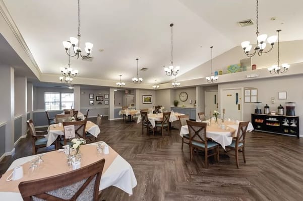 Bright dining room with tables set for meals